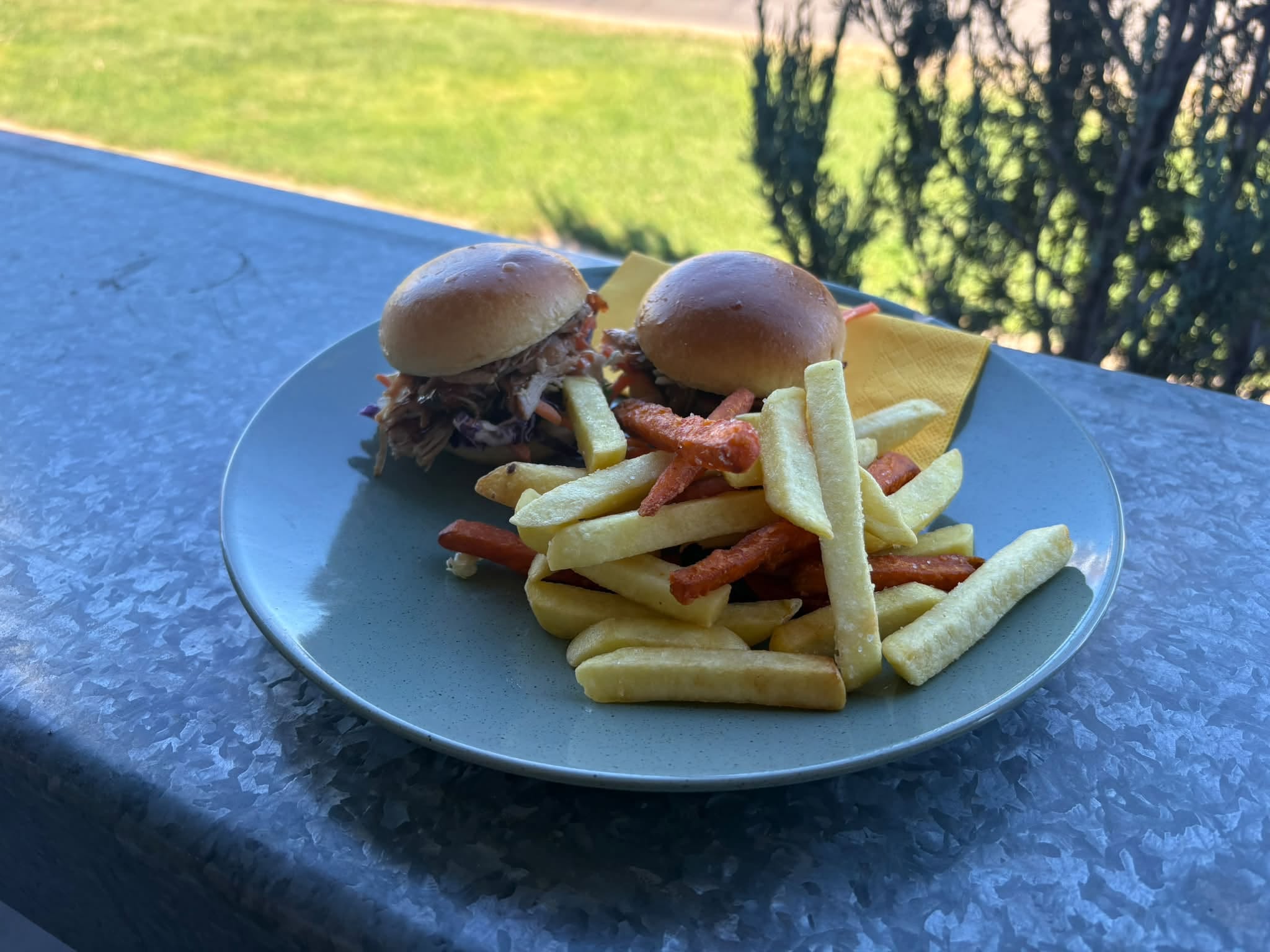 Sliders and mixed chips served on the outdoor table